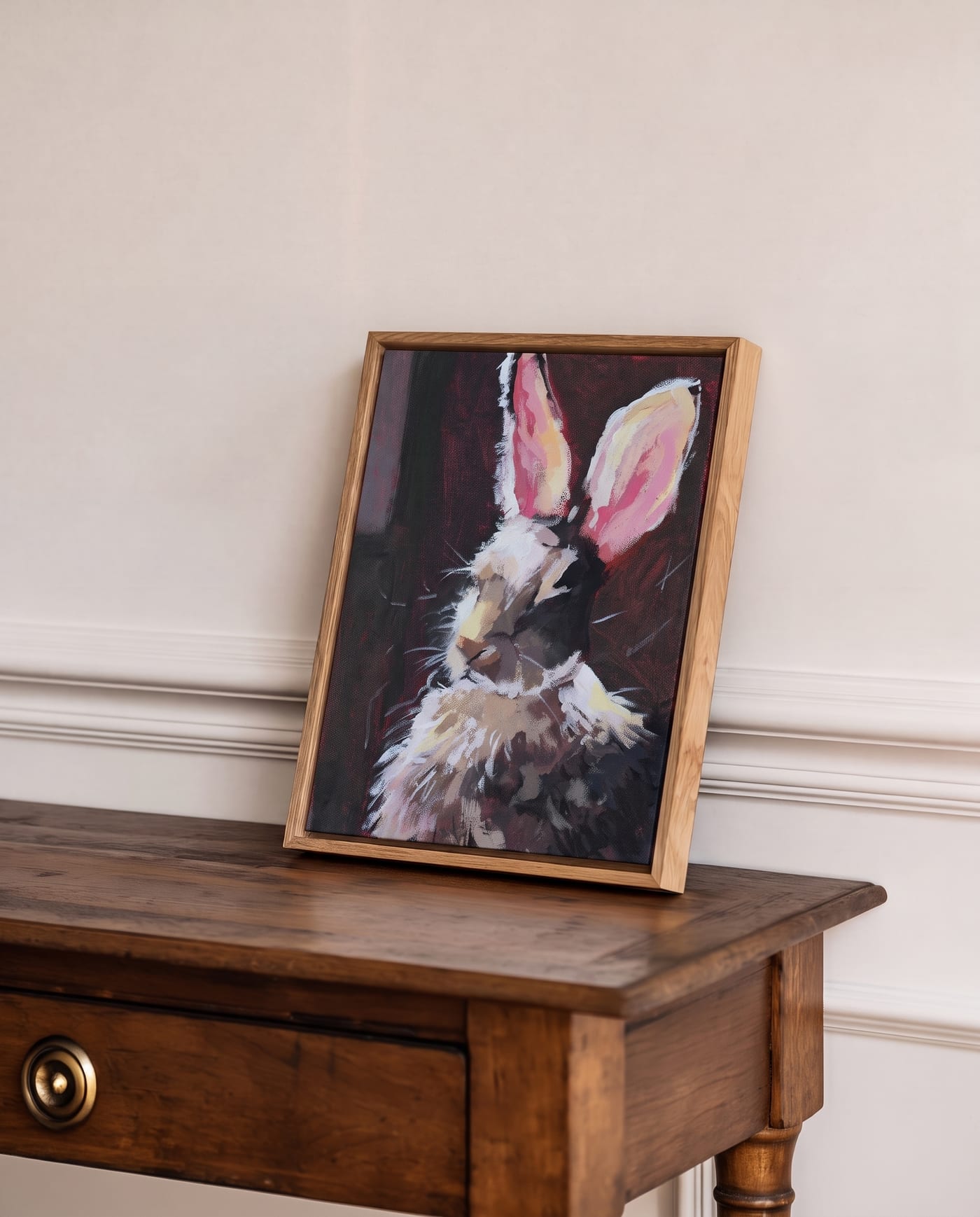 Rabbit painting in a wooden frame leaning on a console table