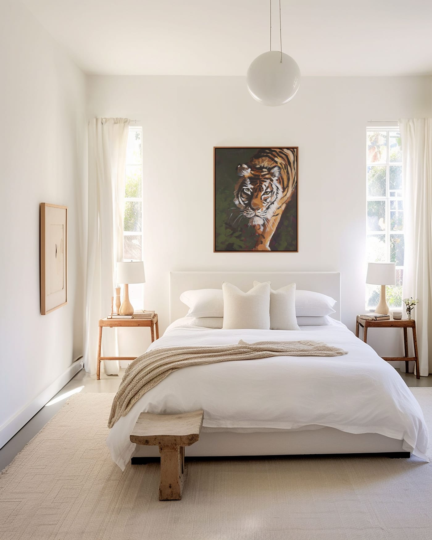 Tiger painting by Aubrey Cobbett hanging above a bed in a bright, airy bedroom
